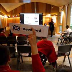 Pupil holding up sign in the Education Centre at Holyrood