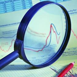 image of a graph and table through a magnifying glass