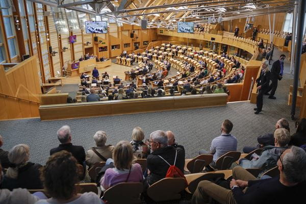 a group of people seated in the public gallery of the debating chamber