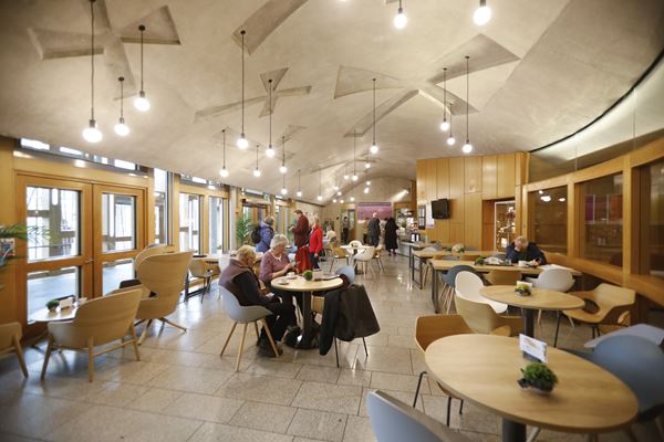 a cafe with people sitting around at different tables