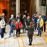 a group of visitors standing in front of a our guide