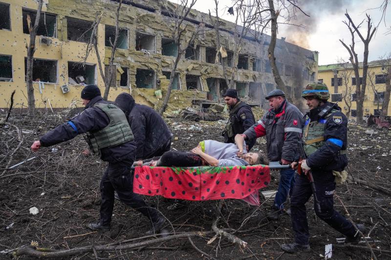 Iryna Kalinina (32), an injured pregnant woman, is carried from a maternity hospital that was damaged during a Russian airstrike in Mariupol, Ukraine, on 9 March 2022. Her baby, named Miron (after the word for ‘peace’) was stillborn, and half an hour later Iryna died as well. An OSCE report concluded the hospital was deliberately targeted by Russia, resulting in three deaths and some 17 injuries. 