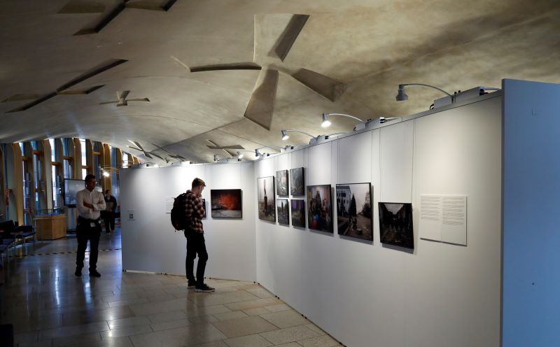 People browse a photography exhibition at the scottish parliament